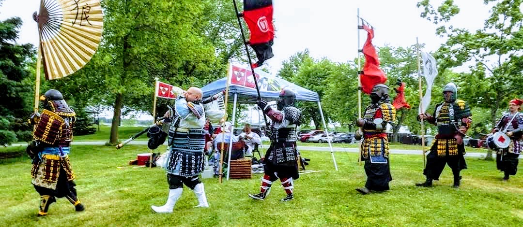 Okami processing in full armour with flags